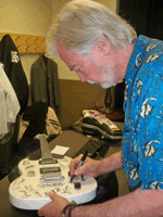 Joe Butler of The Lovin Spoonful autographs Guitar